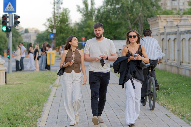 A trio walking along a paved urban path